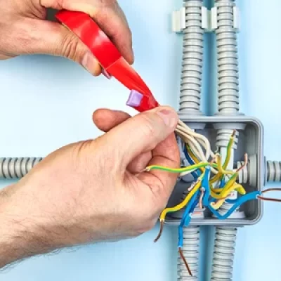 119876480-worker-is-twisting-ends-of-wire-of-junction-box-and-make-insulation-with-heat-shrinkable-tube-and-in